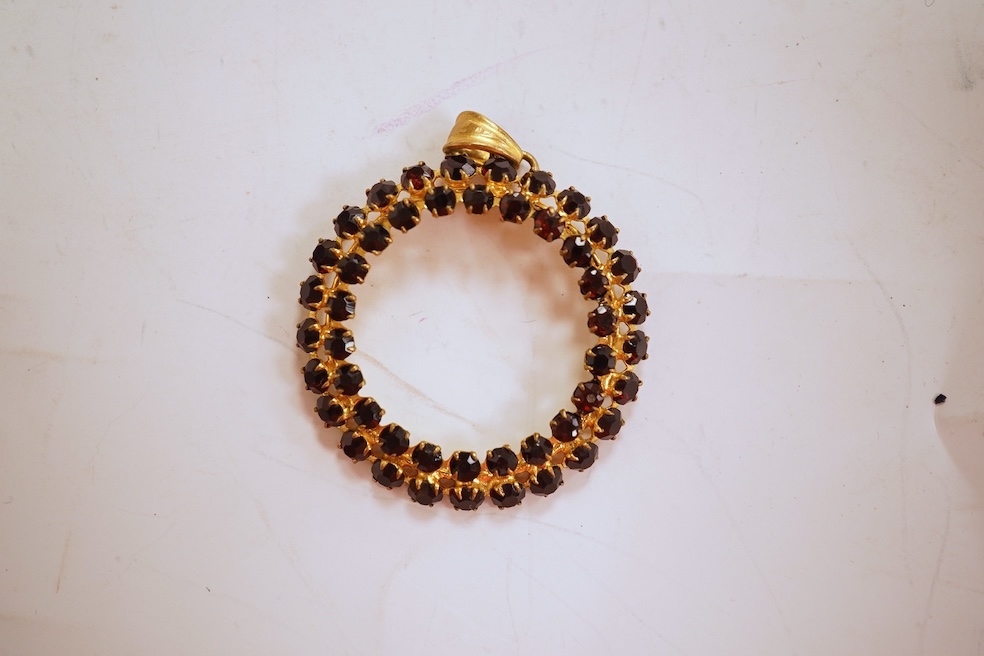 Two necklaces, comprising: a three-strand cultured pearl necklace, to a cabochon garnet and diamond clasp, length 34cm; and a paste and gilt metal pendant on a gold chain, chain length 44cm, stamped 14K, gross weight of